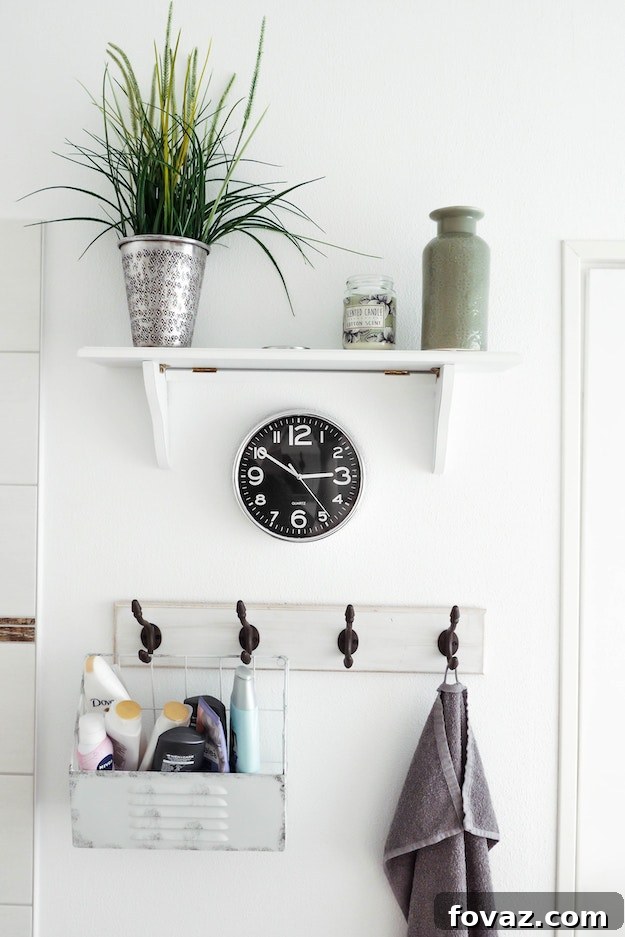 Modern small bathroom design with floating shelves and wall hooks