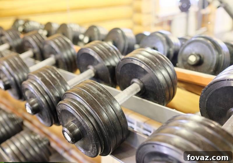 Build Your Own Dumbbell Rack: Smart Storage Ideas for Your Home Gym 2 Sturdy multi-tier DIY dumbbell rack for home gym organization, holding various sizes of dumbbells