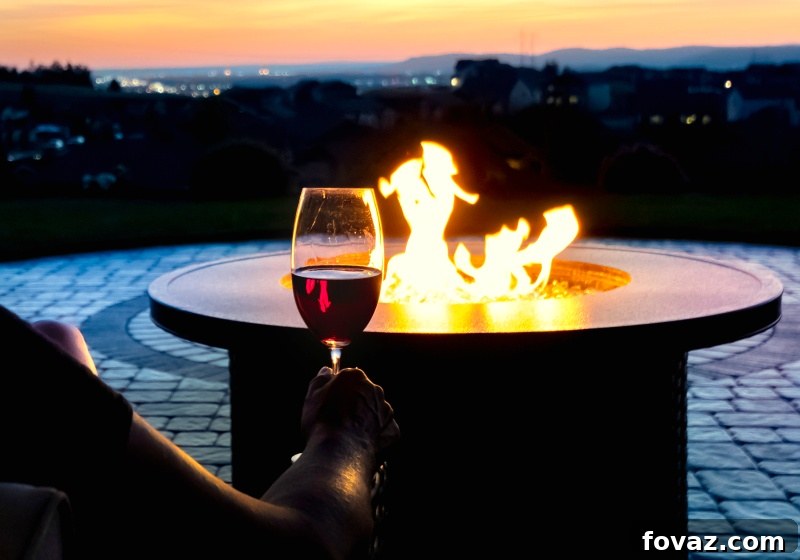 Woman relaxing with a glass of wine by a custom DIY propane fire pit at sunset, enjoying a chill evening. The fire pit, crafted from a flower pot, provides a warm and inviting ambiance for a cozy outdoor experience.