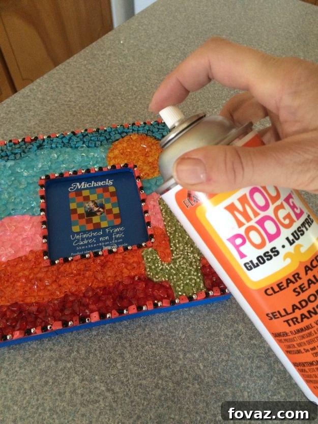 Completed DIY Mosaic Picture Frame with intricate beadwork and painted background, showcasing a personalized saguaro cactus design