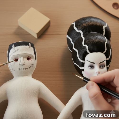 Sew Your Own Spooky Sweethearts Frankenstein Cloth Dolls 11 Adding red veins to Frankenstein's eyes and outlining Mrs. Frankenstein's features with black paint, final details