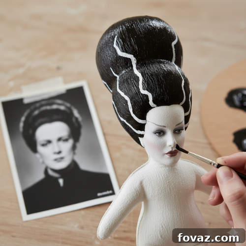 Sew Your Own Spooky Sweethearts Frankenstein Cloth Dolls 6 Painting the iconic hair details for the Bride of Frankenstein doll, adding white hair accents and black squiggles