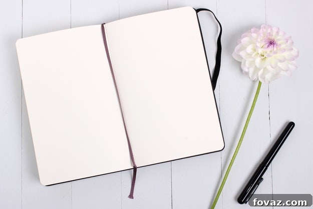 Handmade prayer journal on a wooden surface with a pen and a small plant, conveying a sense of peace and reflection.