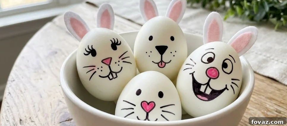 Close-up of three white hard-boiled eggs decorated with cute black and pink bunny faces using markers.