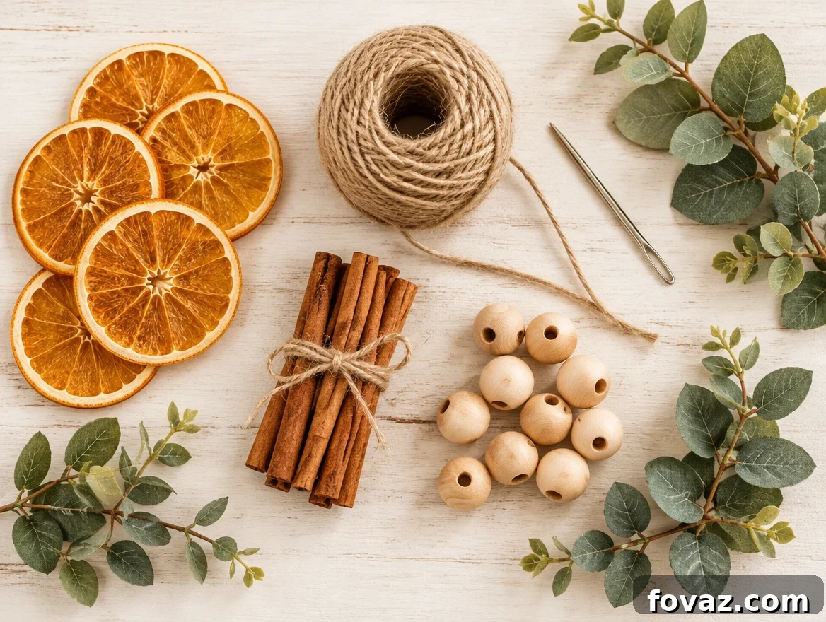 How to Make a Dried Orange Garland and Attach the Slices 3 Overhead flat lay of dried orange garland supplies: orange slices, twine, cinnamon bundles, beads, and eucalyptus